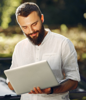 Handsome man in a white shirt. Businessman working with laptop. Man standing near a car